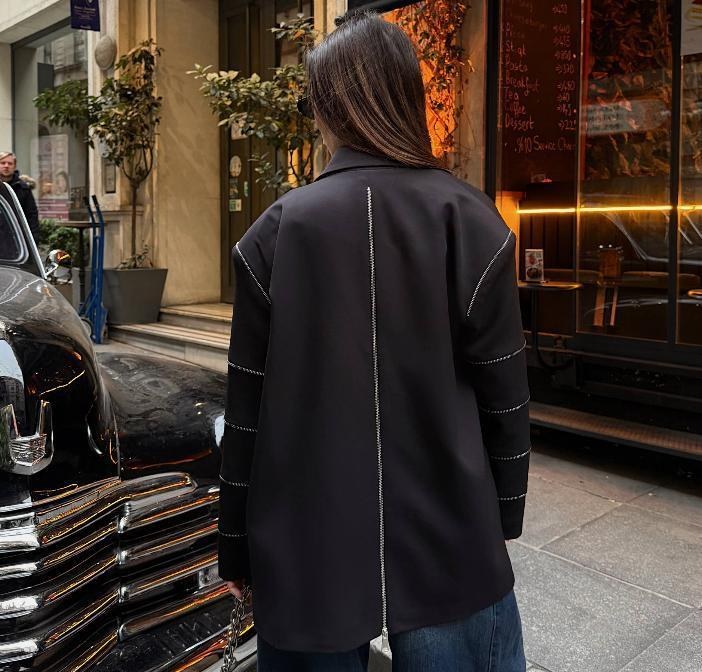 Back view of a dark jacket with contrast seam detail